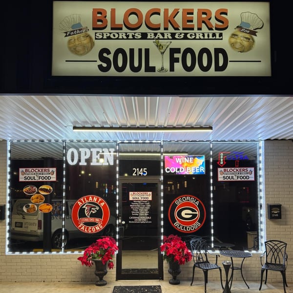 Exterior of Blockers Soul Food Restaurant & Sports Bar at night, with illuminated signs and storefront.